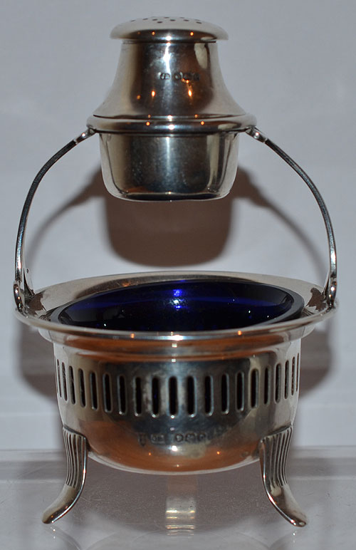 UNUSUAL SILVER SALT & PEPPER COMBINATION ON STAND.