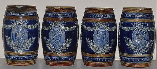 COMPLETE COLLECTION OF FOUR DOULTON WW1 COMEMORATIVE JUGS.