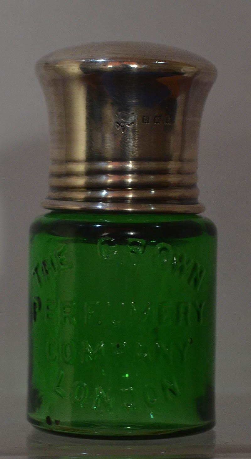 CROWN PERFUMEY BOTTLE WITH SILVER TOP.
