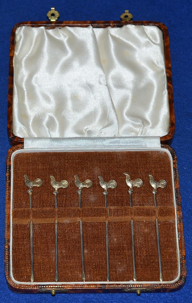 CASED SET OF SIX SILVER GILT COCTAIL STICK.